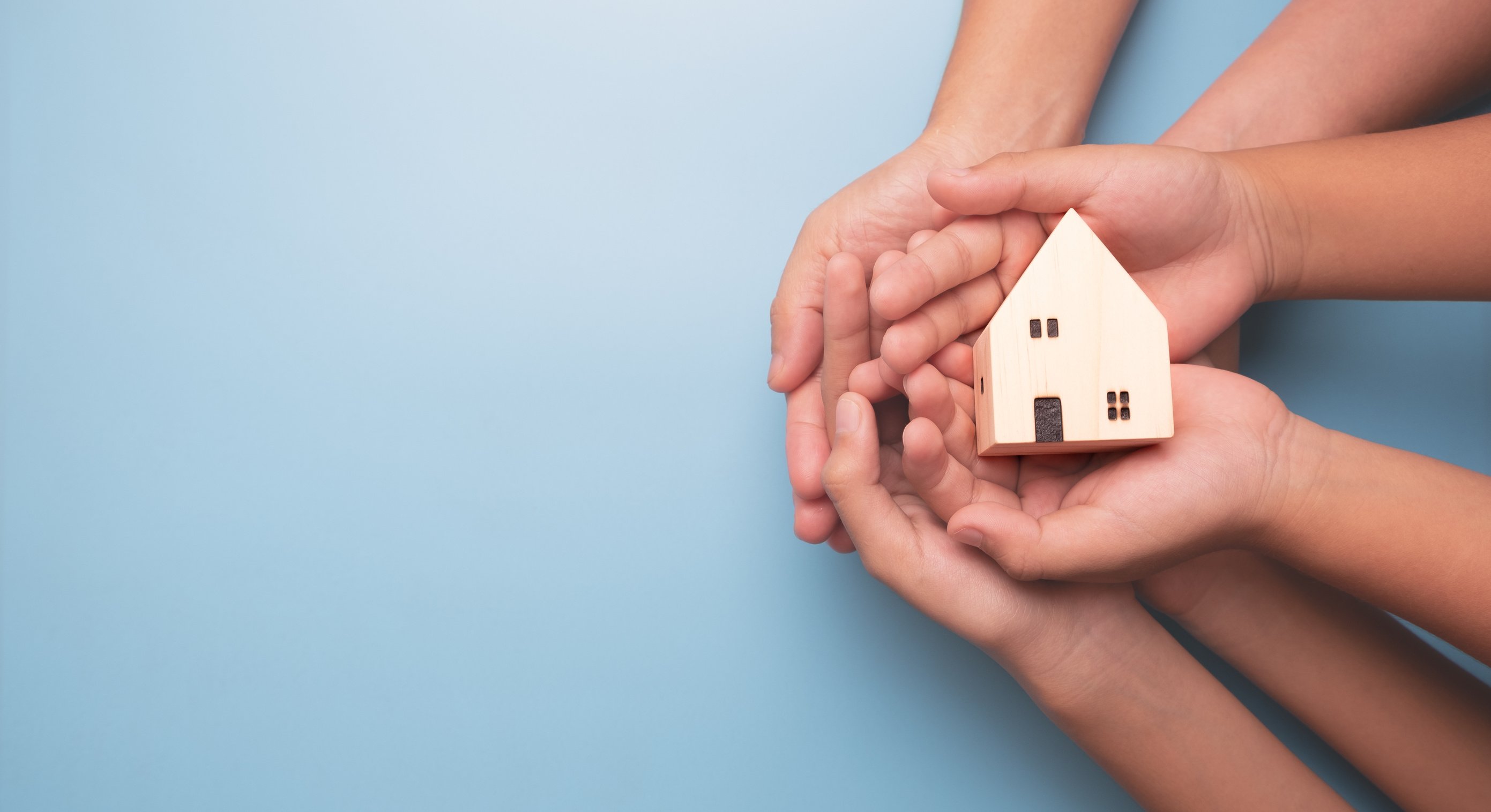 Hands holding wooden house model, real estate, Real estate broker, insurance or loan real estate, business house investment idea, family home